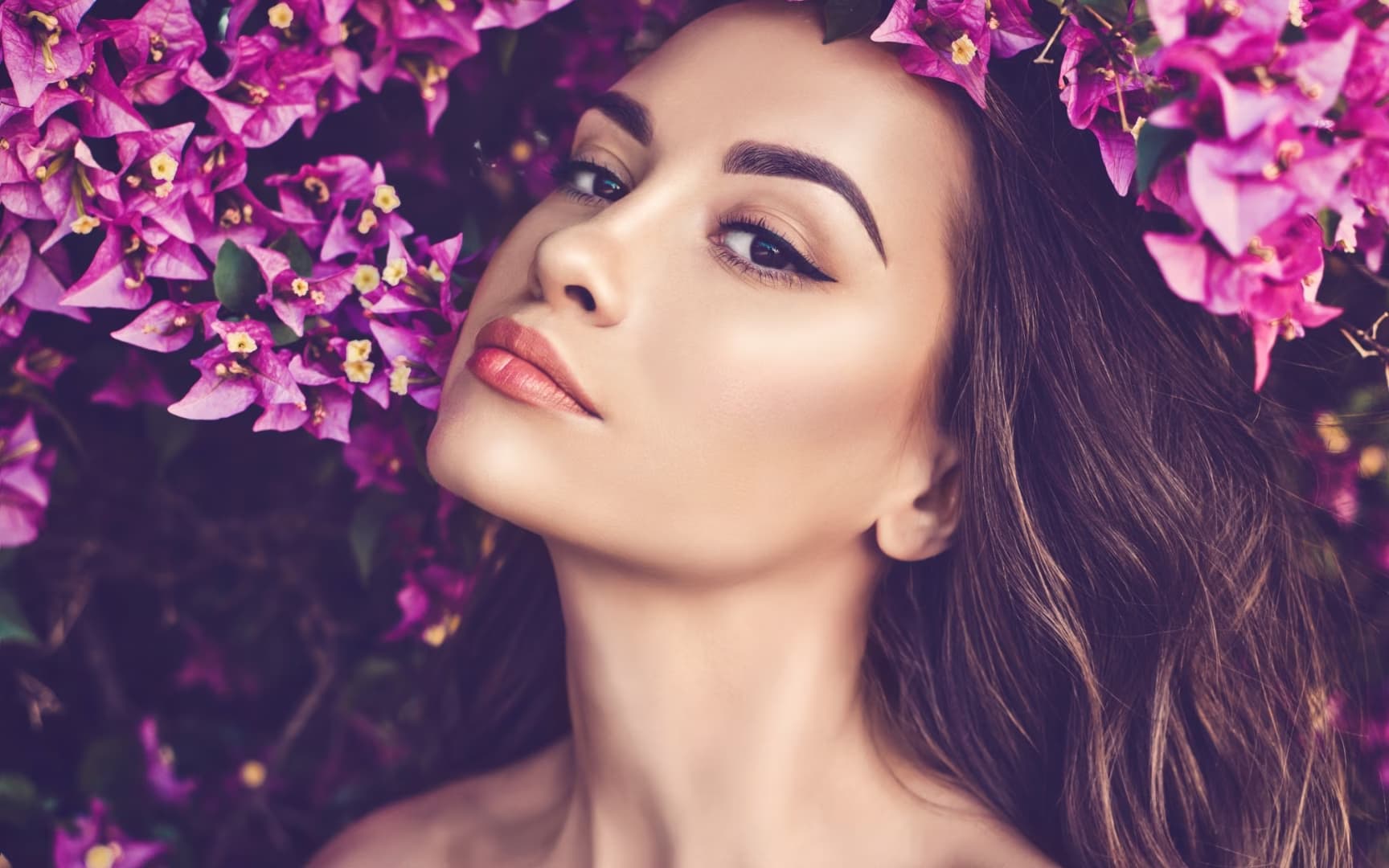 A patient of Ferzli Facial Plastic Surgery photographed among blossom, New York